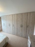 An 8 door hinged fitted wardrobe