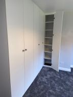 L-shaped hinged wardrobe in white for a walk in wardrobe