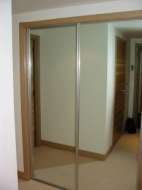 Mirror sliding wardrobe doors with polished silver frames