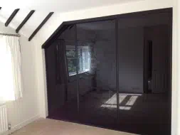 3 Door sliding wardrobes with black glass doors in black frames, fitted in Teesside