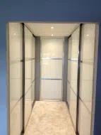 Polished Silver frames with pearl white glass divided into 3 equalpieces with a doube sided door hidding the en suite - fitted in Darlington