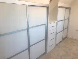 Satin white glass center section with panels in a matt silver frame, fitted in Teesside