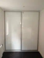Pure white glass full panel doors with a matt silver frame, fitted in Newton Aycliffe
