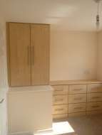 Fitted cupboard on box above the stairs with a fitted 9 drawer chest