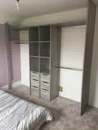 Dark Artwood wardrobe interior shelves and drawer in the middle and hanging either side, fitted in Whitby