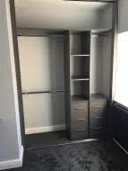 Graphite grey sliding wardrobe fitted in a small alcove, installed in Fairfield