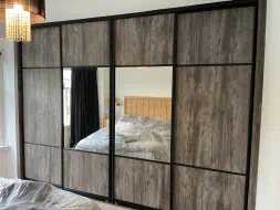 Casadina Pine sliding doors half the doors having mirror and the other half been all wood while maintaining the design, fitted in Linthorpe