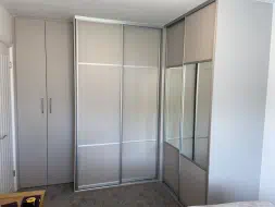L shaped wardrobes in cashmere with satin silver frames, fitted in Acklam