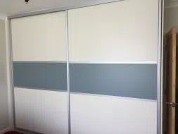 White panel doors with a fjord green strip in the middle, fitted in Kirklevington