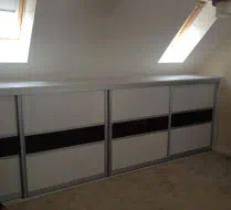 Very short doors in whitewood with a black strip dividing it in half, fitted in Bishop Auckland